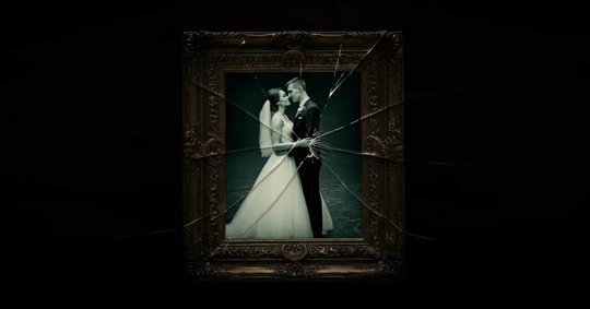 wedding photo in a broken frame with a dark background