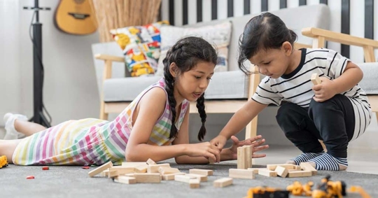 children playing with blocks in a room