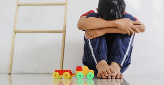 child hiding his face