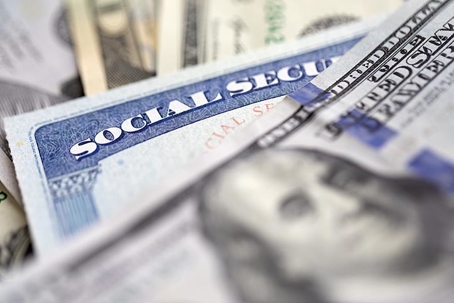 social security card and US banknotes conveying Social security benefit concept