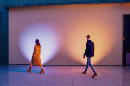 young couple walking away in a dark alley