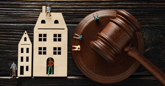 toy wooden house with a gavel next to it