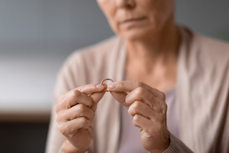 Elderly woman looking at wedding ring