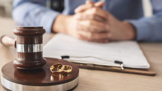 Gavel with wedding rings