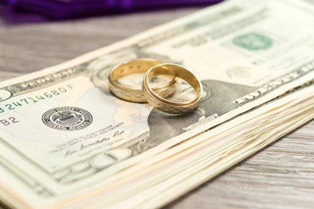 wedding rings on top of money