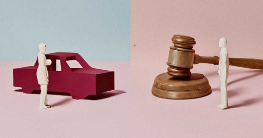 A red car and a judge's gavel, with small figures on either side, suggesting a car-related legal issue.