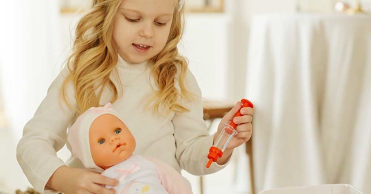 A girl playing a doll