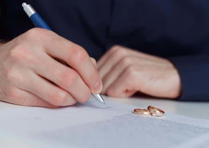 A person is signing documents