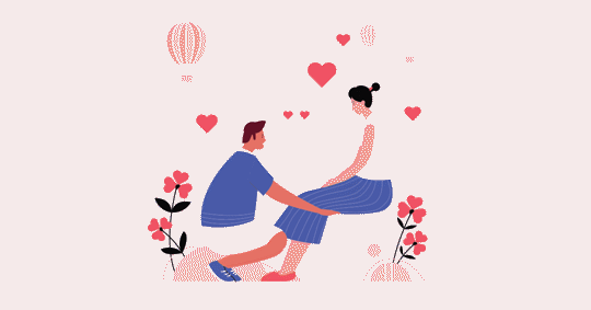 A man and a woman are sitting, the man is kneeling, and they appear to be talking.