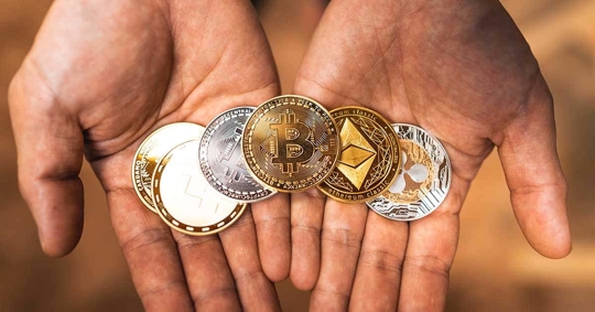 Hands holding various cryptocurrencies