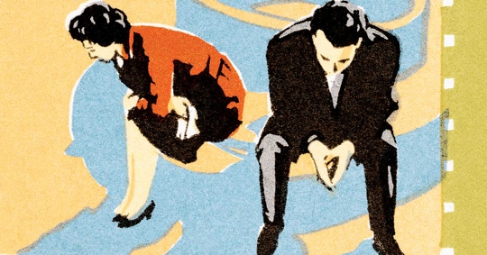 Two people, a woman in an orange dress and a man in a dark suit, are seated, appearing sad or distressed.