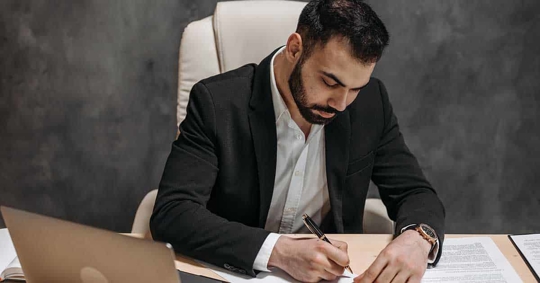 A man signing a paper