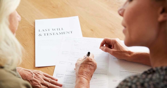Legal documents, a last will and testament, are being signed.